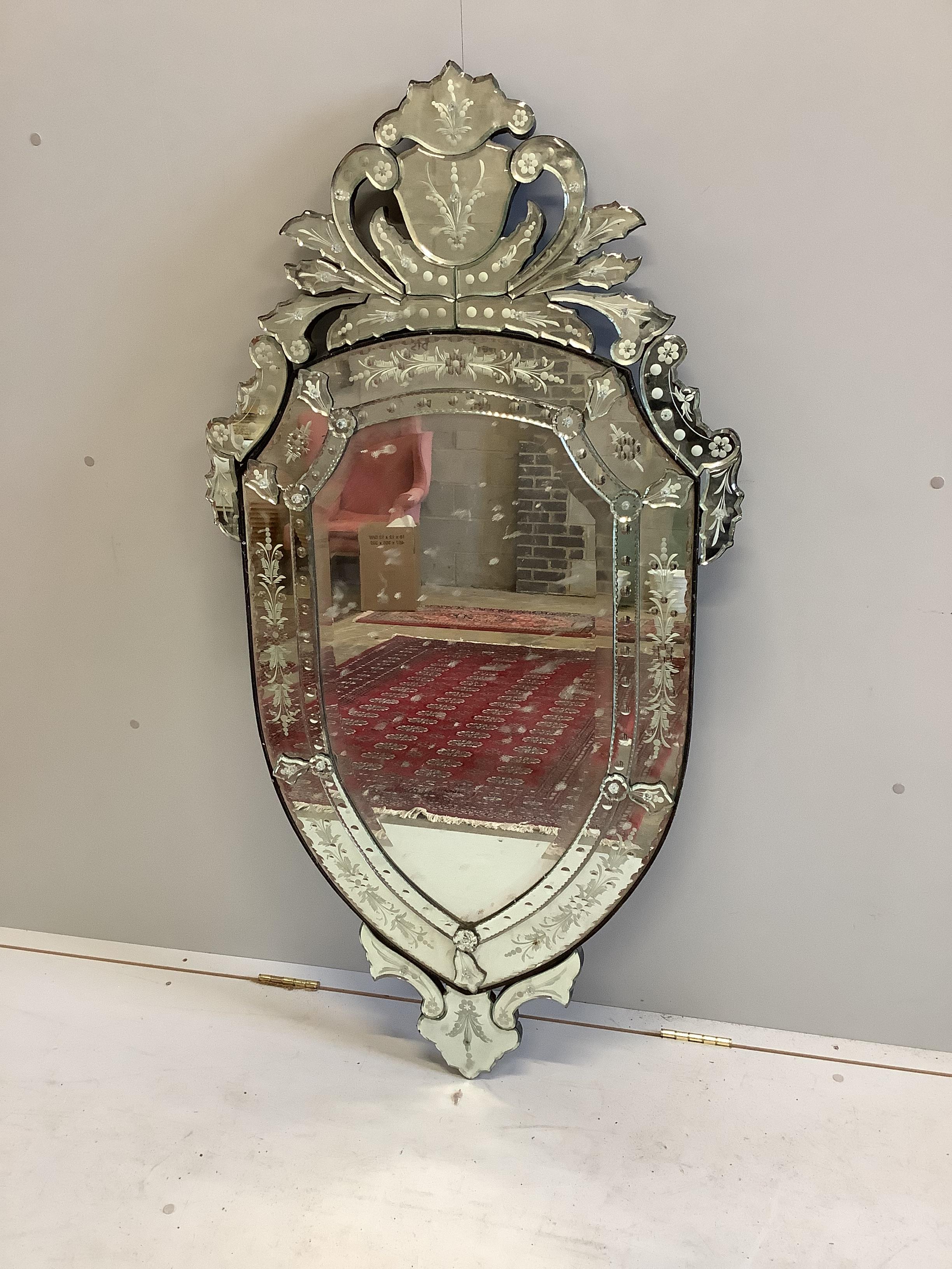 A Venetian style shield shaped etched glass wall mirror, width 72cm, height 138cm